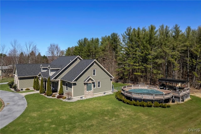 exterior space with a covered pool and a lawn