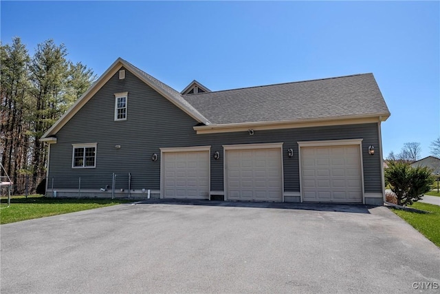 view of property exterior featuring a shingled roof and a garage