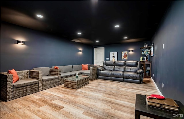 home theater with wood finished floors and recessed lighting