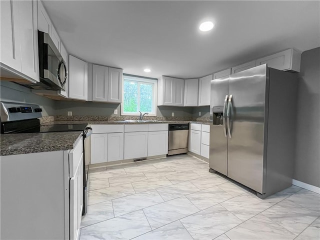 131 W Sullivanville Rd, Veteran, NY 14845 - kitchen with stainless steel appliances, light marble finish floors, a sink, recessed lighting, and dark stone counters