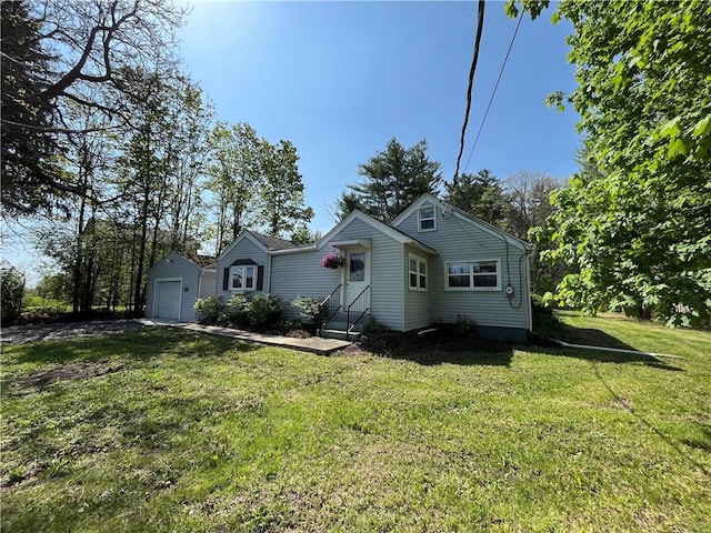 131 W Sullivanville Rd, Veteran, NY 14845 - bungalow featuring an outbuilding, entry steps, a front lawn, and a detached garage