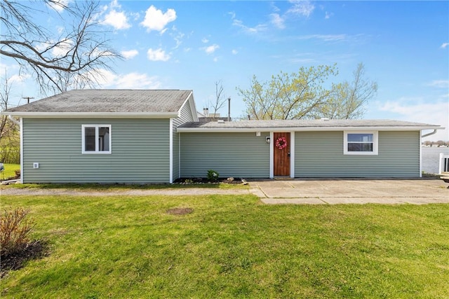 back of property featuring a yard and a patio area