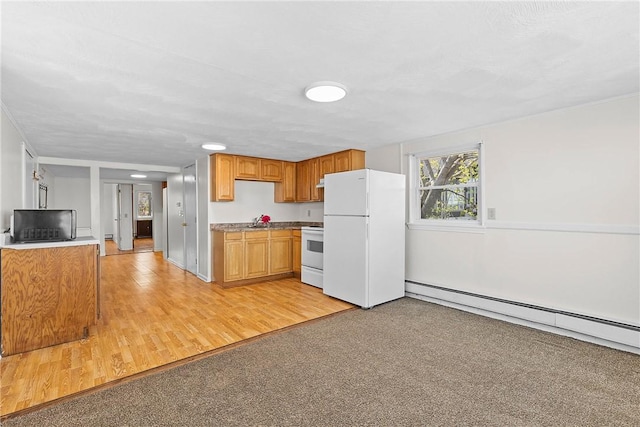 kitchen with light wood-style floors, brown cabinets, baseboard heating, and white appliances