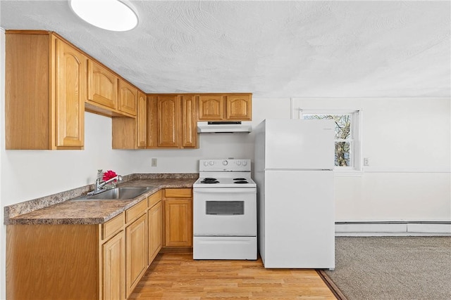 kitchen with baseboard heating, under cabinet range hood, white appliances, a sink, and light wood-style floors