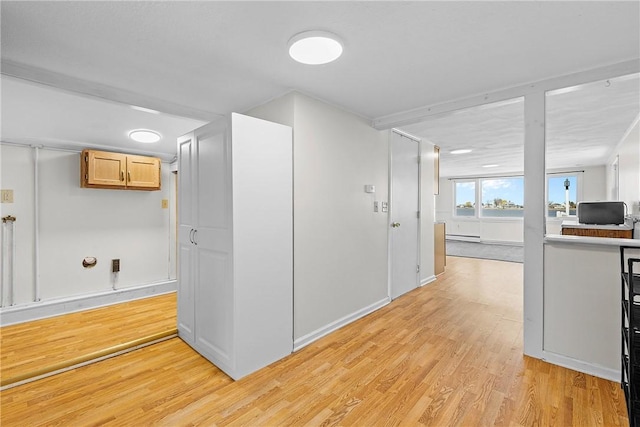 interior space featuring light wood-style flooring and baseboards
