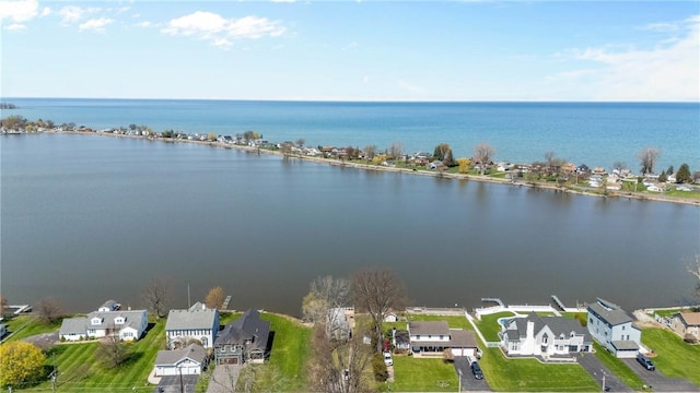 drone / aerial view featuring a water view and a residential view
