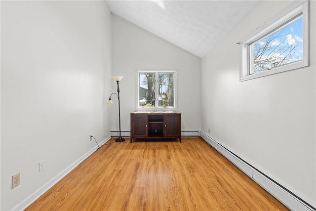 interior space featuring light wood-style floors, baseboards, and a baseboard radiator