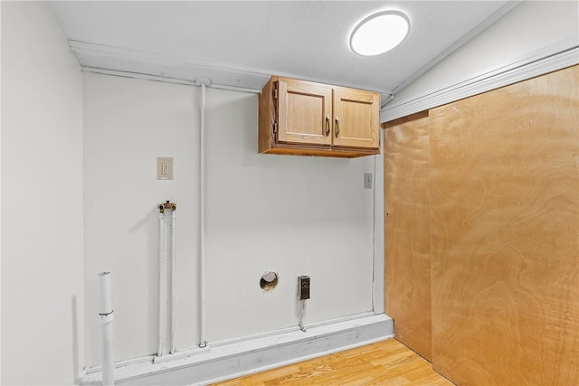 laundry room with light wood-style flooring and cabinet space