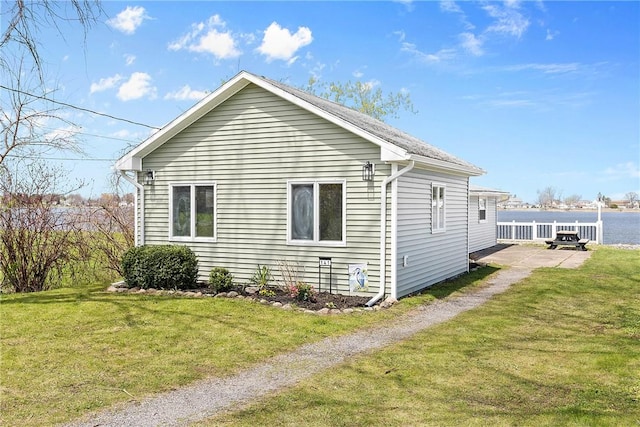 view of side of property featuring a yard