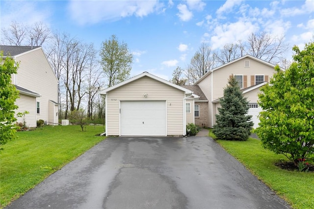 view of front of property with a garage, a front yard, and aphalt driveway