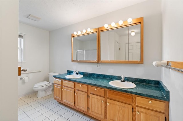full bath featuring double vanity, toilet, tile patterned flooring, and a sink