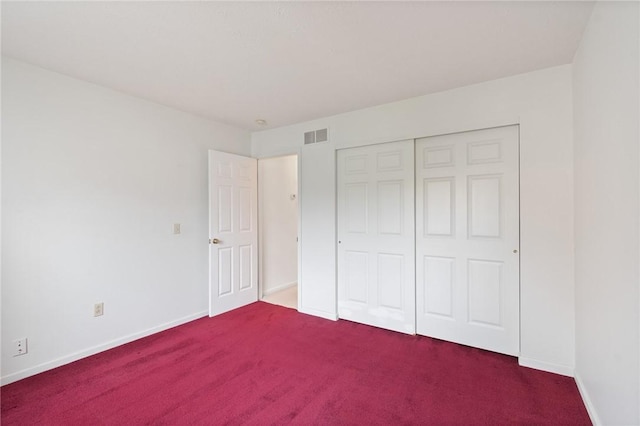 unfurnished bedroom featuring carpet, baseboards, and visible vents