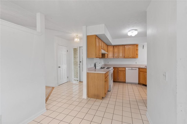 kitchen with under cabinet range hood, baseboards, light tile patterned floors, white appliances, and light countertops