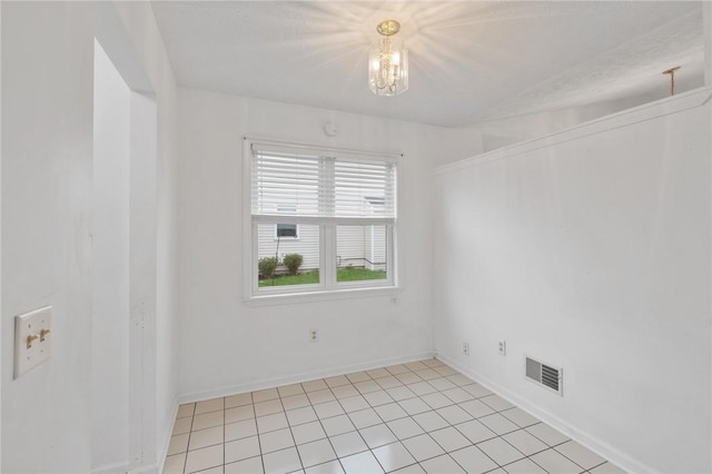unfurnished room with light tile patterned flooring, a chandelier, baseboards, and visible vents