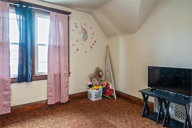 rec room featuring carpet, baseboards, and lofted ceiling