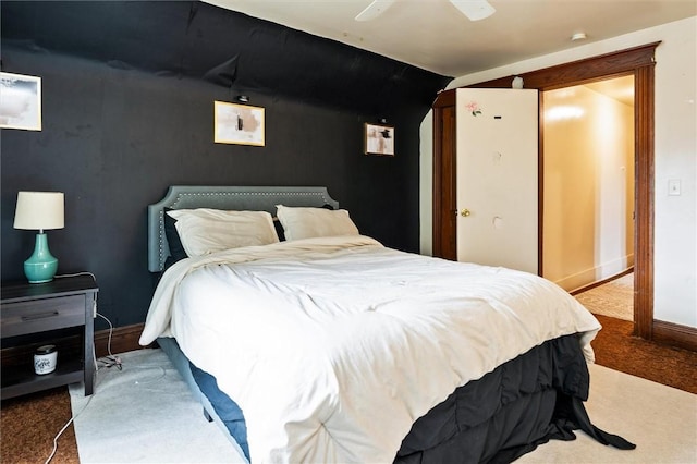 carpeted bedroom featuring lofted ceiling, baseboards, and a ceiling fan