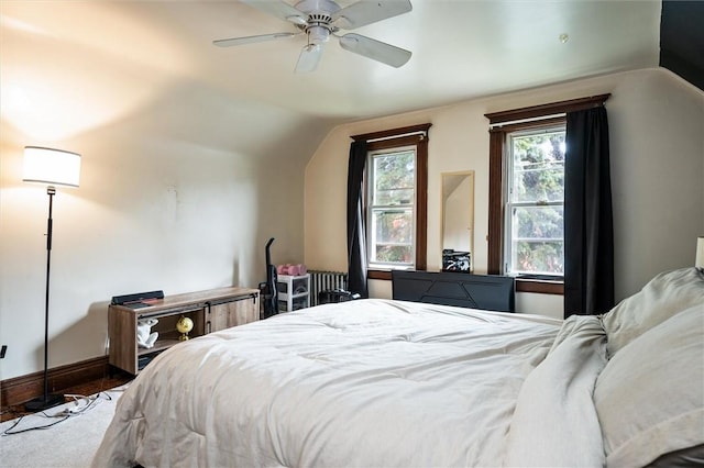 bedroom featuring lofted ceiling, baseboards, a ceiling fan, and radiator heating unit