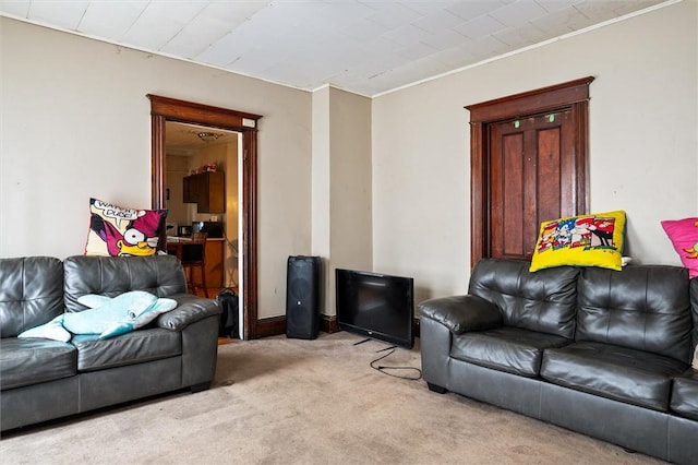 living area featuring light carpet and ornamental molding
