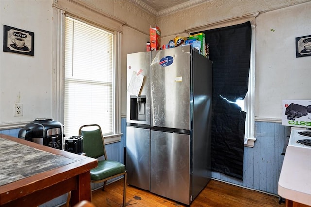 kitchen featuring stainless steel fridge, plenty of natural light, and wood finished floors
