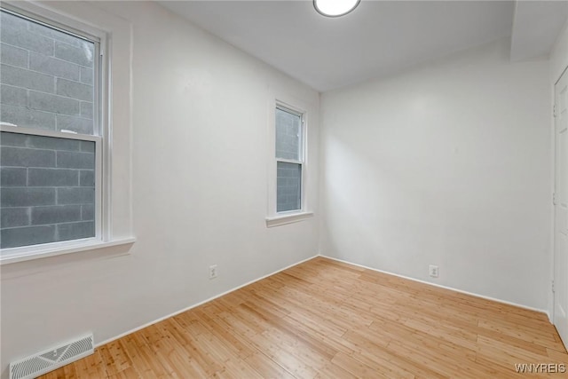 unfurnished room featuring visible vents and wood finished floors