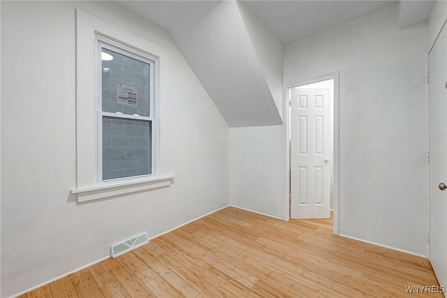 bonus room with light wood-type flooring and visible vents