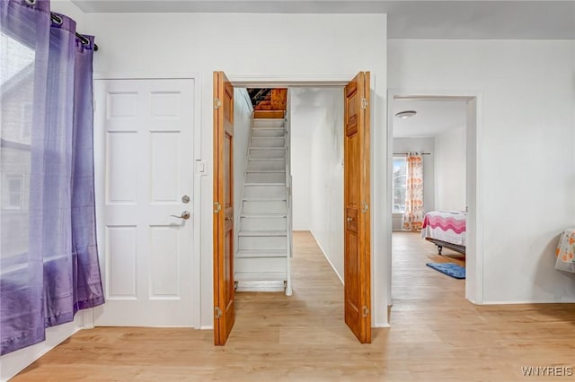 interior space with light wood-style flooring and stairs