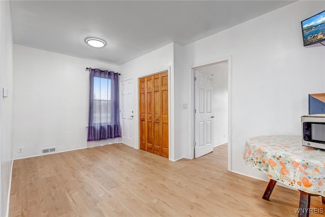 bedroom featuring visible vents and wood finished floors