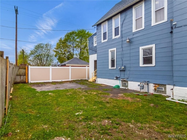 back of house with a yard, a patio area, and a fenced backyard