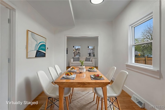 dining area featuring a wealth of natural light, baseboards, visible vents, and light wood-style floors