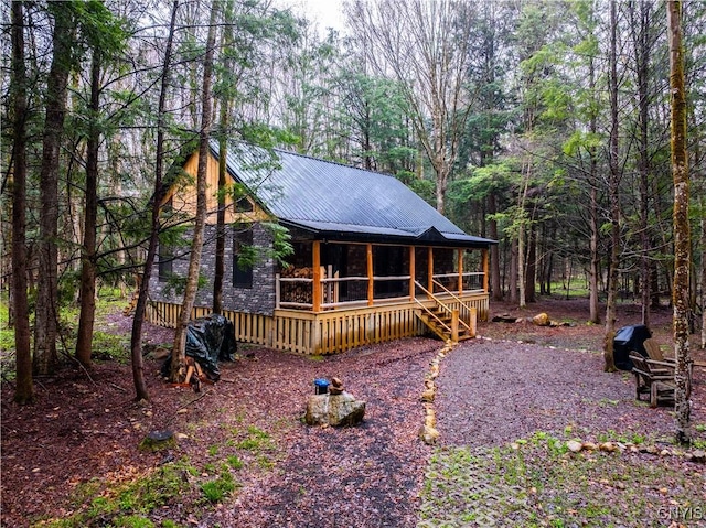 2323 State Route 29, Salisbury, NY 13329 - view of front of house featuring covered porch, a wooded view, and metal roof