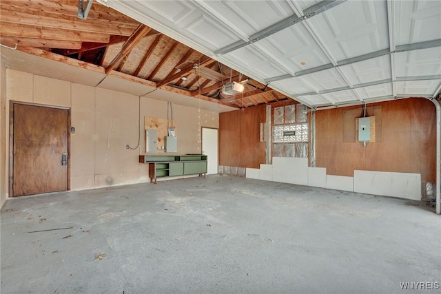 garage featuring electric panel and a garage door opener