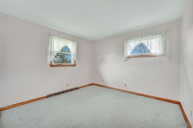carpeted empty room with visible vents and baseboards