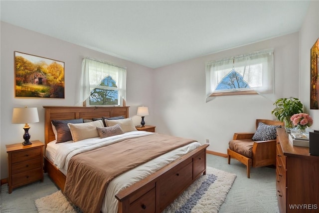bedroom featuring baseboards and light colored carpet
