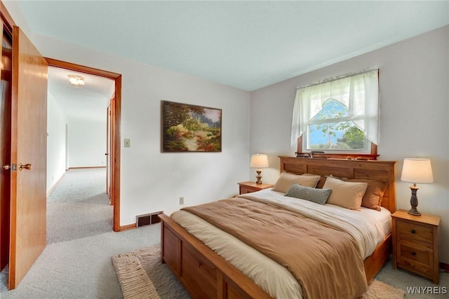 bedroom featuring light carpet and visible vents