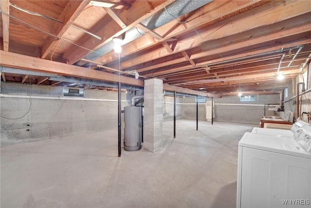 below grade area with washing machine and clothes dryer and gas water heater