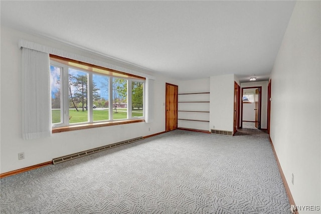 unfurnished room featuring a baseboard radiator, light colored carpet, and baseboards