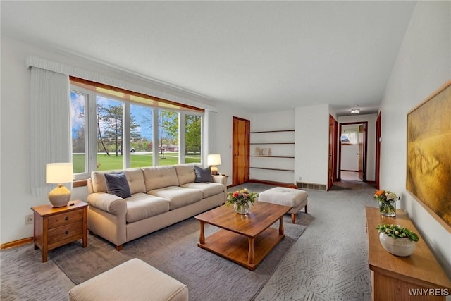 carpeted living area with baseboards and visible vents