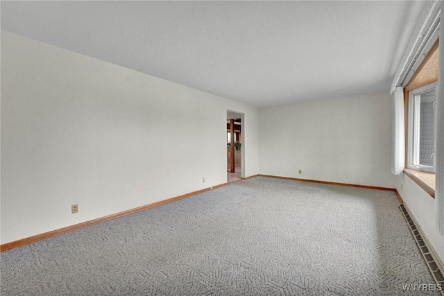 carpeted empty room with baseboards