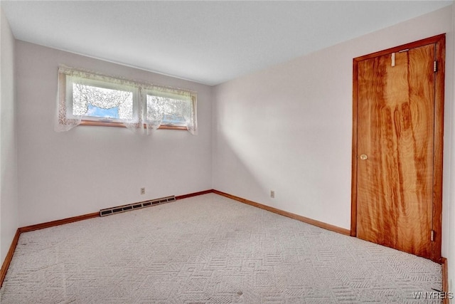 carpeted spare room with baseboards and visible vents