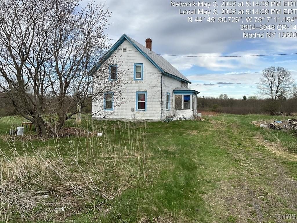 4012 County Route 14, Madrid, NY 13660 - rear view of house featuring a chimney
