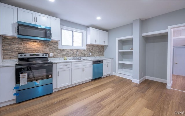 kitchen with dishwashing machine, a sink, black range with electric stovetop, stainless steel microwave, and light countertops