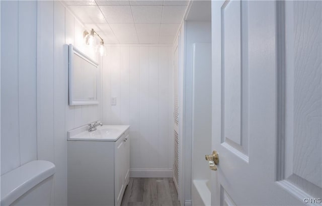 full bathroom featuring toilet, vanity, and wood finished floors