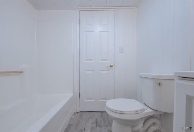 full bath featuring toilet and wood finished floors