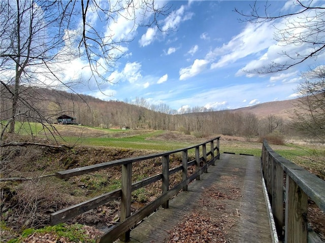 exterior space with a wooded view and a rural view