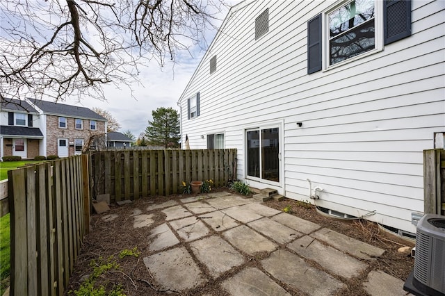 view of patio with fence and cooling unit