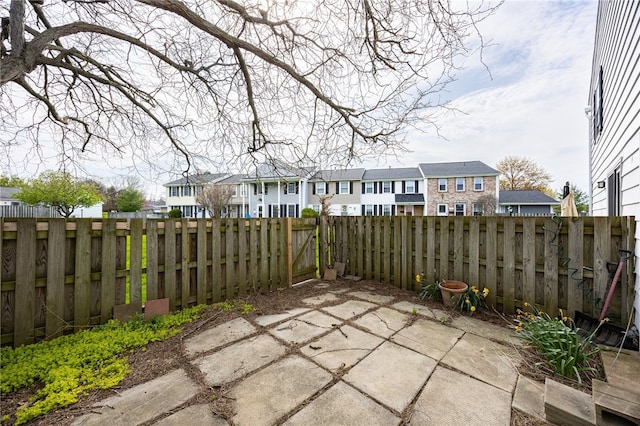 view of patio / terrace with a residential view and a fenced backyard