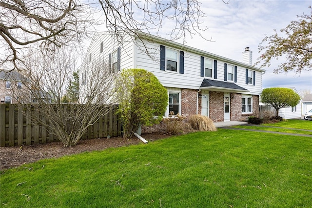 view of front of home with a chimney and brick siding
