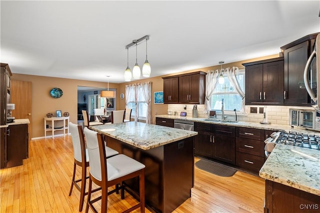 kitchen with a sink, plenty of natural light, and backsplash