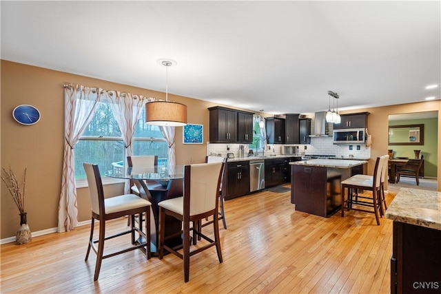 dining room with light wood finished floors and baseboards