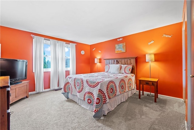 carpeted bedroom featuring baseboards